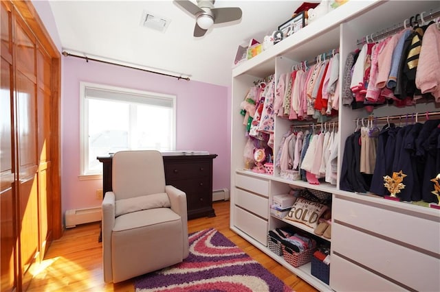 interior space with a baseboard heating unit and visible vents