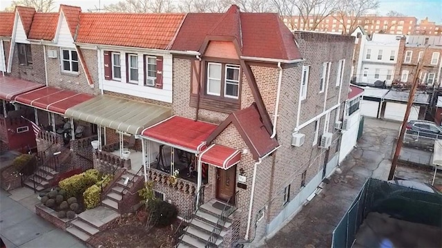 exterior space featuring brick siding and a wall mounted AC