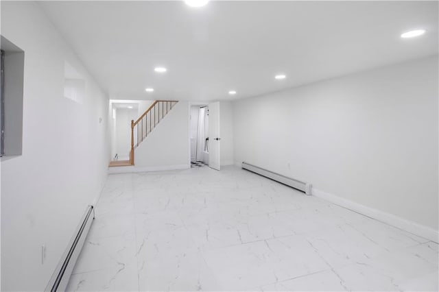 finished basement with marble finish floor, stairs, a baseboard heating unit, and recessed lighting