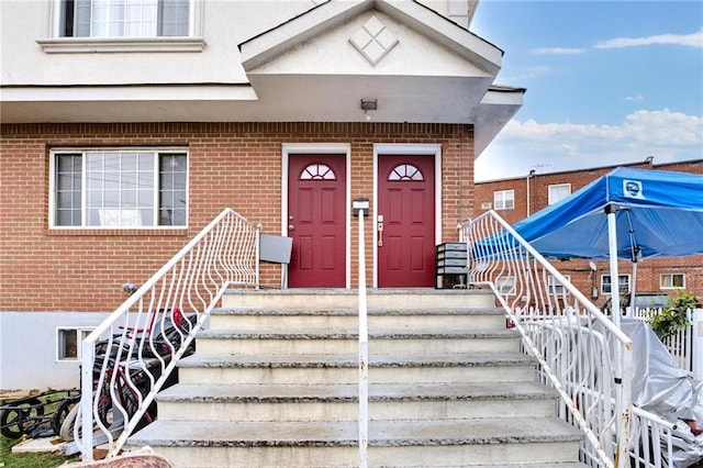 entrance to property with brick siding