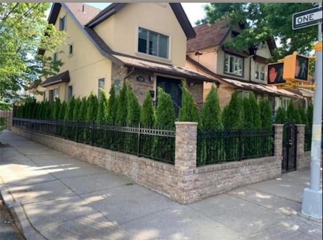 view of front of home with a fenced front yard and stucco siding