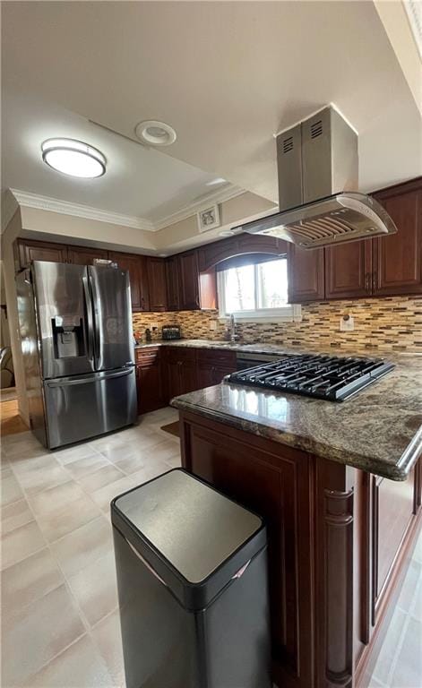 kitchen featuring stainless steel fridge, tasteful backsplash, dark stone countertops, a peninsula, and crown molding