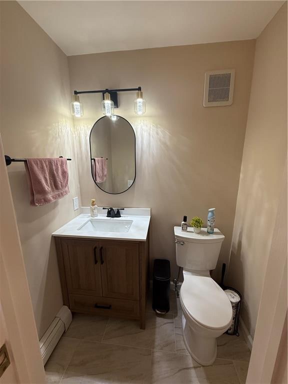 half bath with visible vents, toilet, baseboard heating, vanity, and baseboards