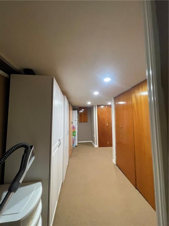 hall featuring recessed lighting and light carpet