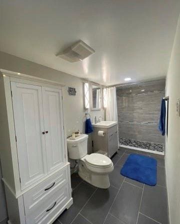 bathroom featuring vanity, tile patterned flooring, a shower stall, and toilet