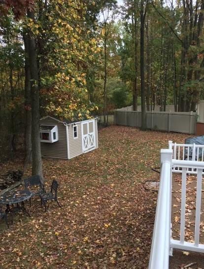 view of yard featuring fence, an outdoor structure, and a storage shed