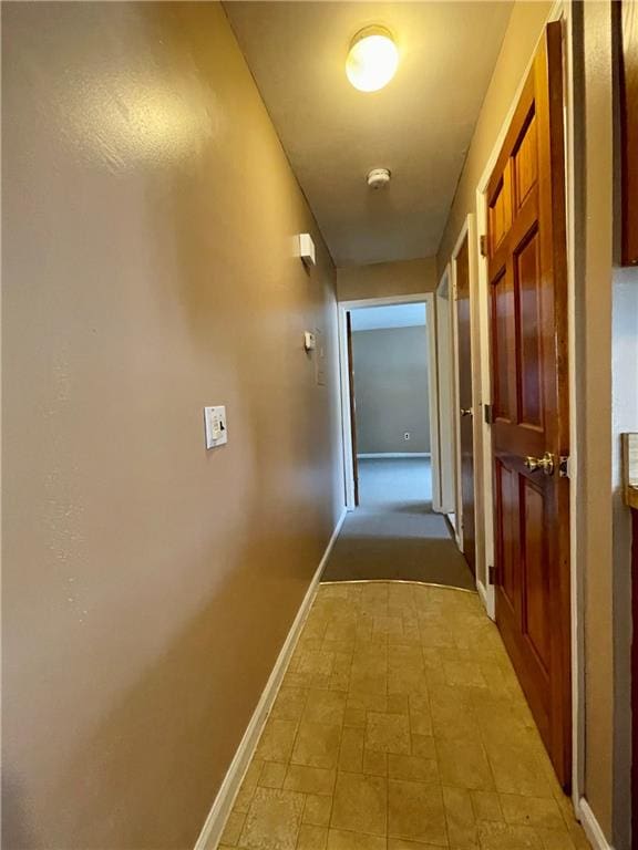 hallway featuring baseboards