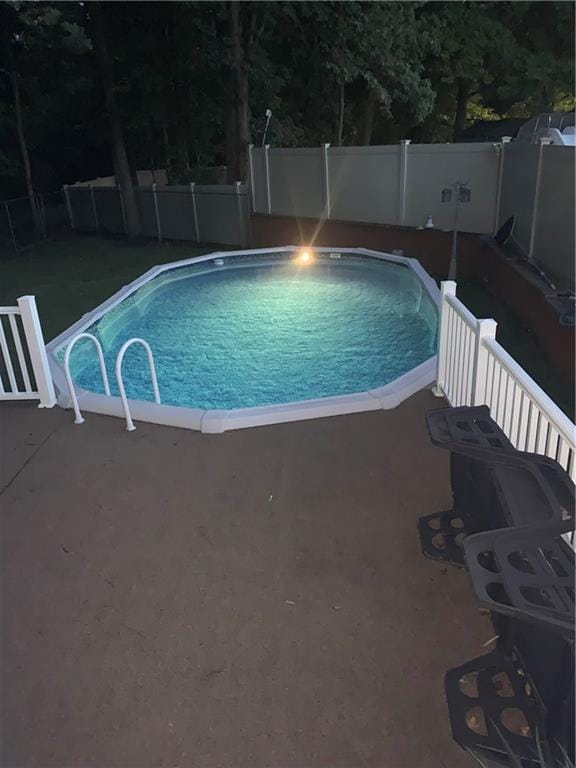 view of pool featuring a patio area, a fenced backyard, and a fenced in pool