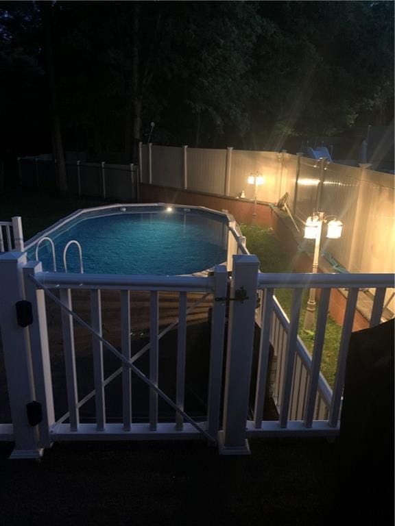 pool at twilight featuring fence