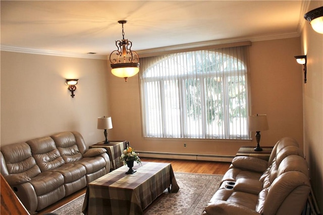 living area with ornamental molding, a baseboard radiator, and wood finished floors