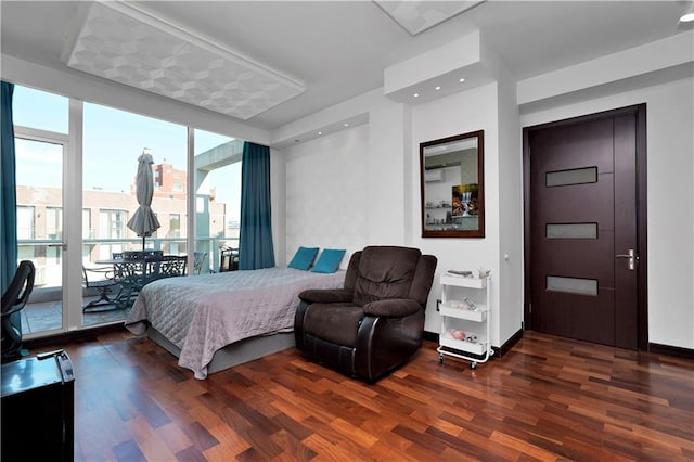 bedroom with recessed lighting, expansive windows, baseboards, and wood finished floors