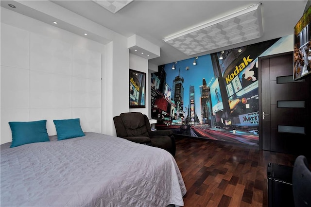 bedroom with a wall of windows and wood finished floors