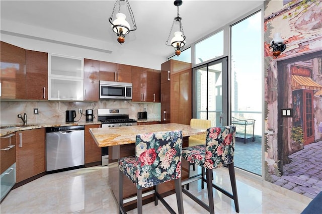 384 Neptune Ave Unit 601, Brooklyn, NY 11235 - kitchen featuring decorative backsplash, pendant lighting, appliances with stainless steel finishes, and a sink