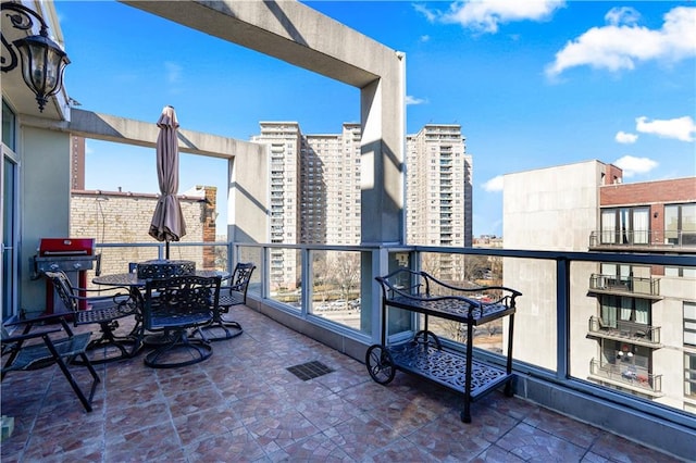 balcony featuring visible vents and a view of city