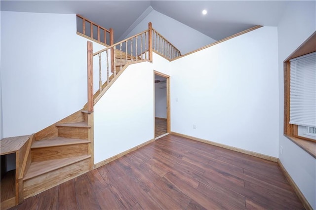 stairway featuring recessed lighting, wood finished floors, and baseboards