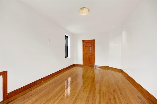 spare room with light wood finished floors, baseboards, and recessed lighting