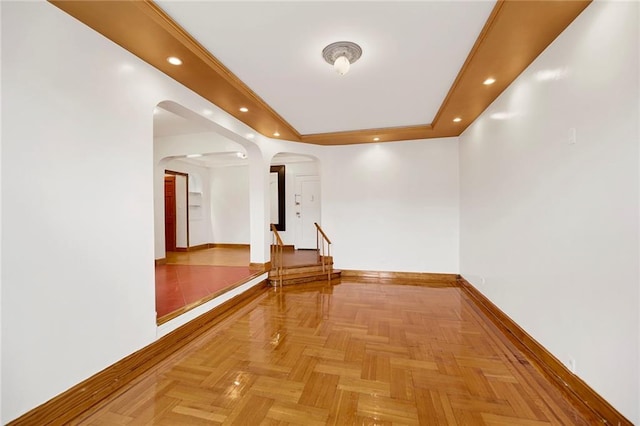 corridor with baseboards, arched walkways, and recessed lighting