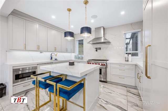 kitchen with oven, a sink, marble finish floor, wall chimney exhaust hood, and stainless steel range