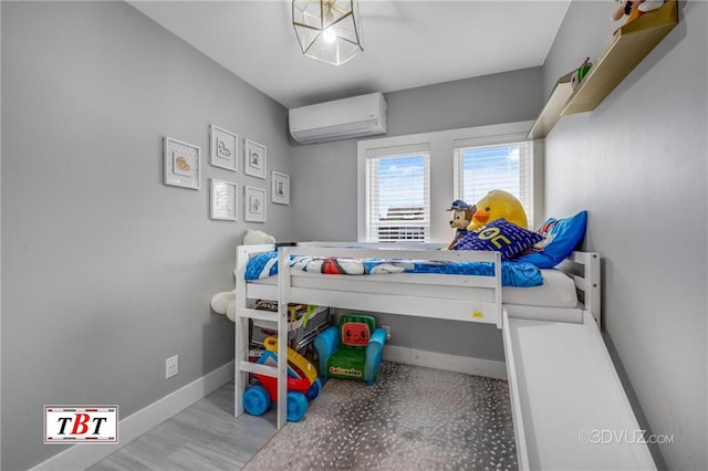 bedroom featuring a wall mounted air conditioner and baseboards