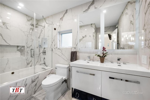 full bath featuring shower / bath combination with glass door, tile walls, double vanity, toilet, and stone wall