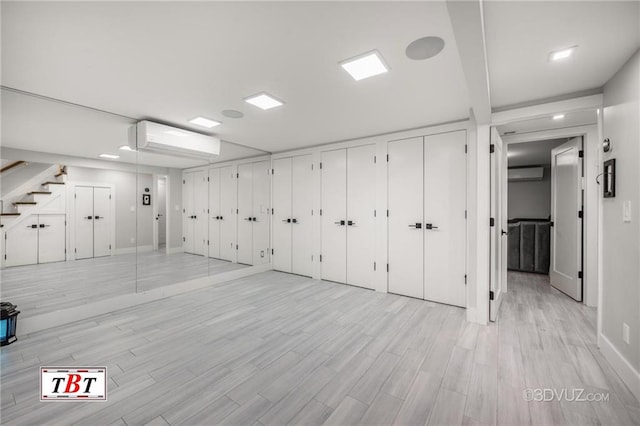 garage featuring an AC wall unit and a wall mounted air conditioner