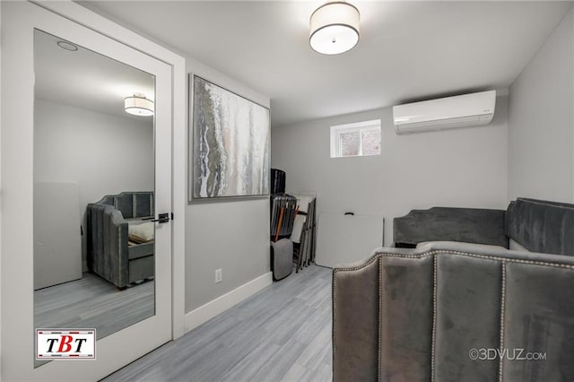 living room with baseboards, wood finished floors, and a wall mounted AC