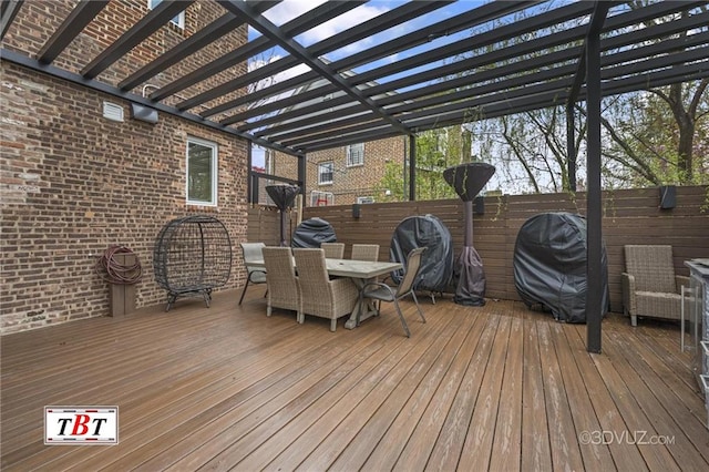 wooden deck featuring fence, a pergola, and outdoor dining space