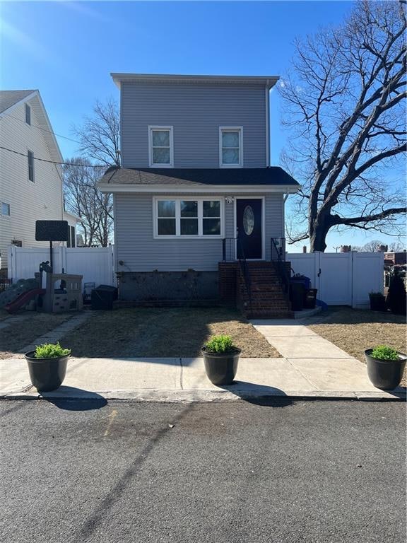 view of front of property featuring fence and crawl space
