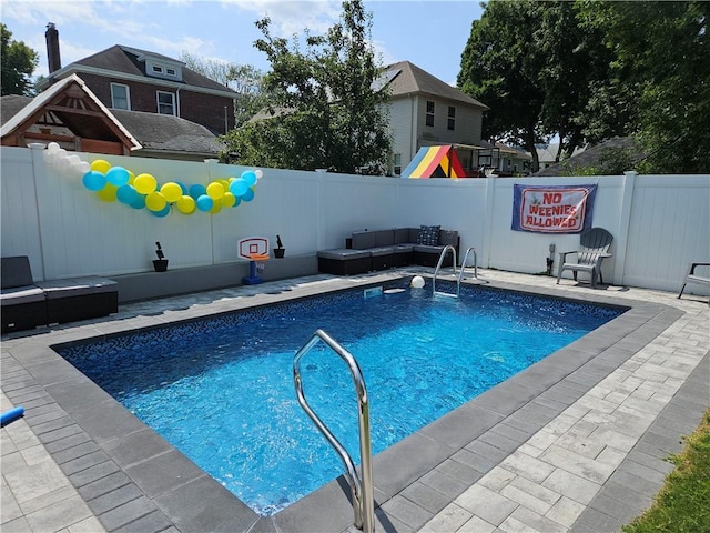 view of pool with outdoor lounge area, a playground, a patio area, and a fenced backyard