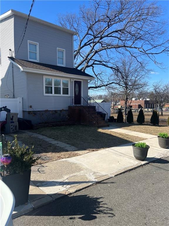 view of front of home featuring fence