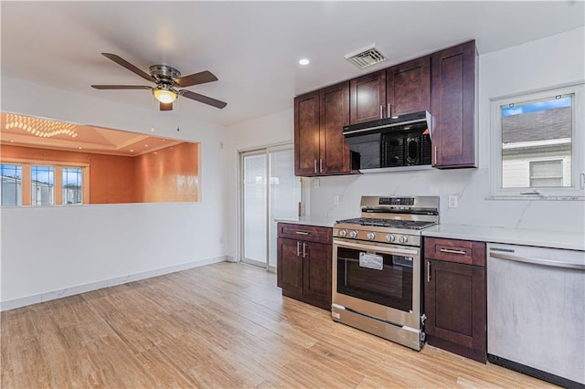 kitchen with baseboards, light wood finished floors, visible vents, light countertops, and appliances with stainless steel finishes