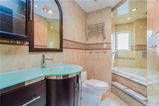 full bathroom with vanity, radiator, tiled bath, tile walls, and toilet