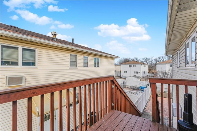 deck with a residential view and fence