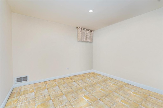 empty room with recessed lighting, baseboards, and visible vents