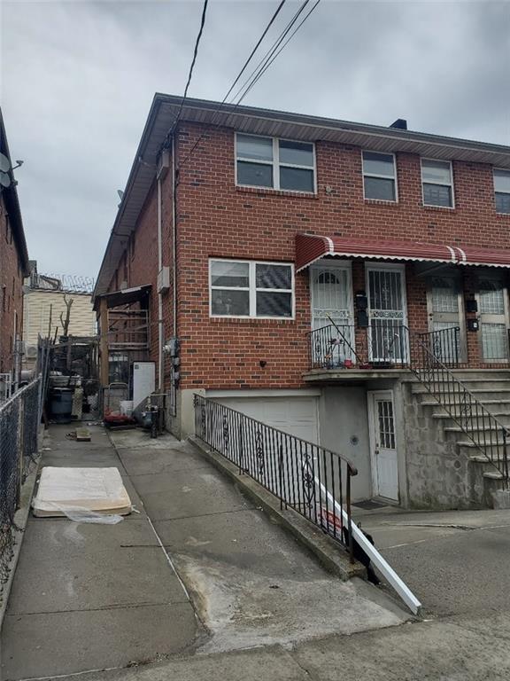 back of property with fence and brick siding