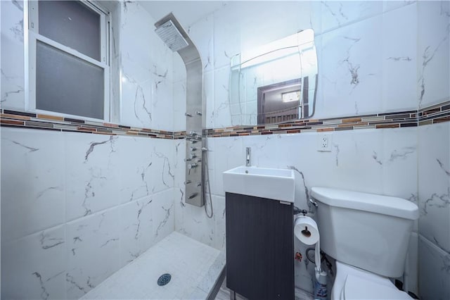 full bath featuring toilet, tiled shower, and vanity