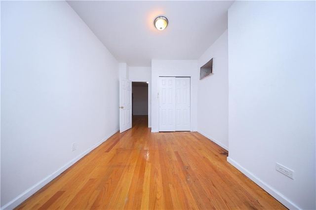 interior space featuring baseboards and light wood-style floors