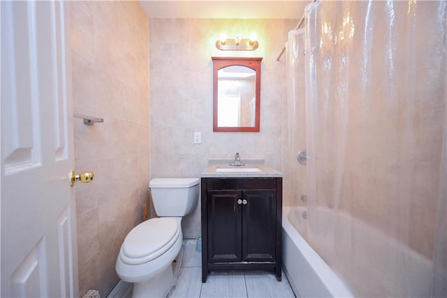 full bathroom featuring shower / bathtub combination with curtain, tile walls, toilet, and vanity