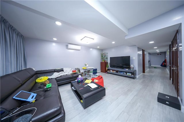 living area featuring a wall unit AC, light wood-type flooring, baseboards, and recessed lighting