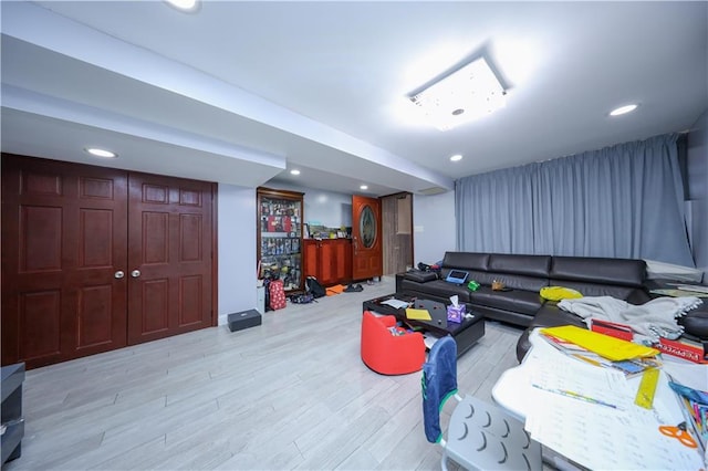 living room with wood finished floors and recessed lighting