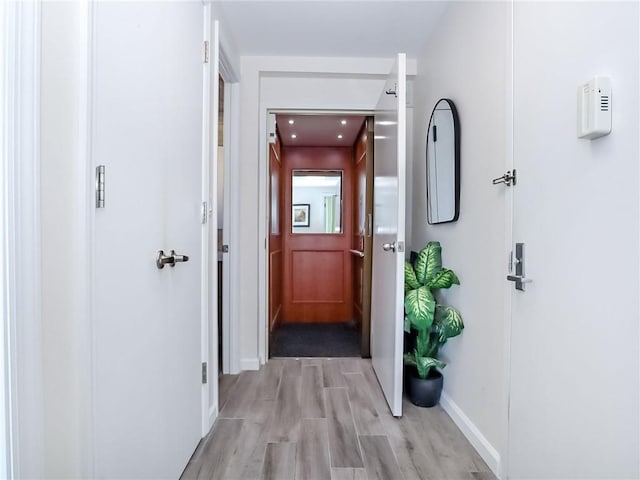 hallway featuring baseboards