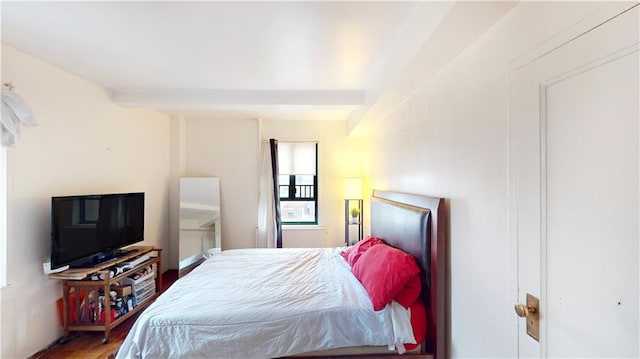 bedroom with beam ceiling