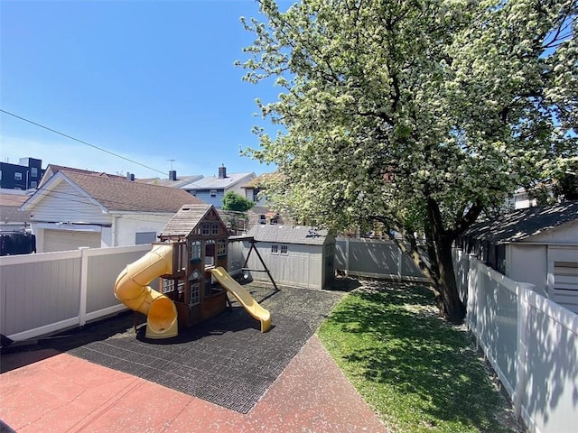 view of patio featuring a fenced backyard, a playground, and a residential view