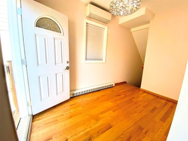 interior space featuring a baseboard heating unit and a wall mounted air conditioner