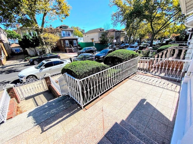 view of patio / terrace with a residential view and a porch