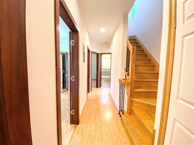 hallway featuring light wood-style floors and recessed lighting
