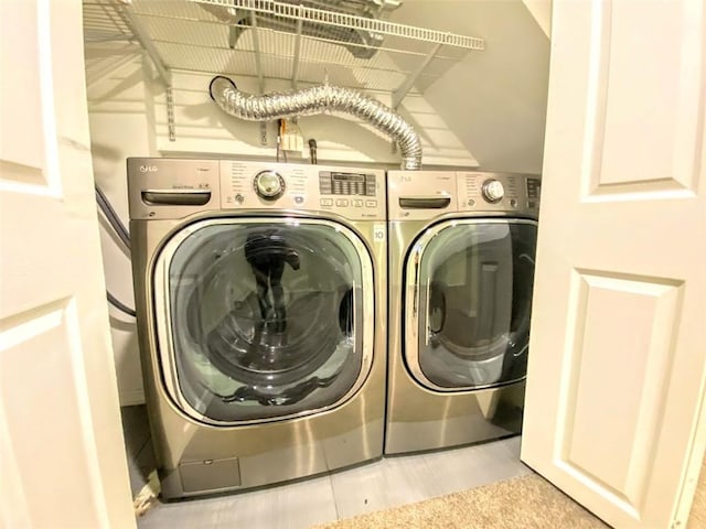 clothes washing area with washer and dryer and laundry area