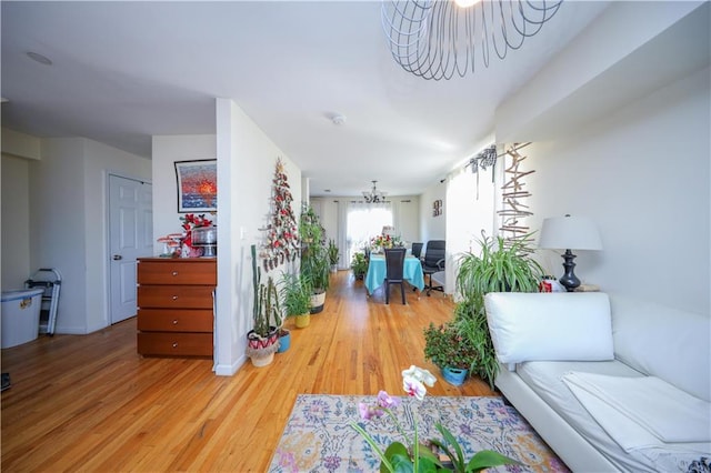 interior space featuring an inviting chandelier and light wood finished floors