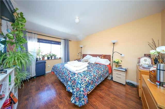 bedroom featuring wood finished floors and baseboards