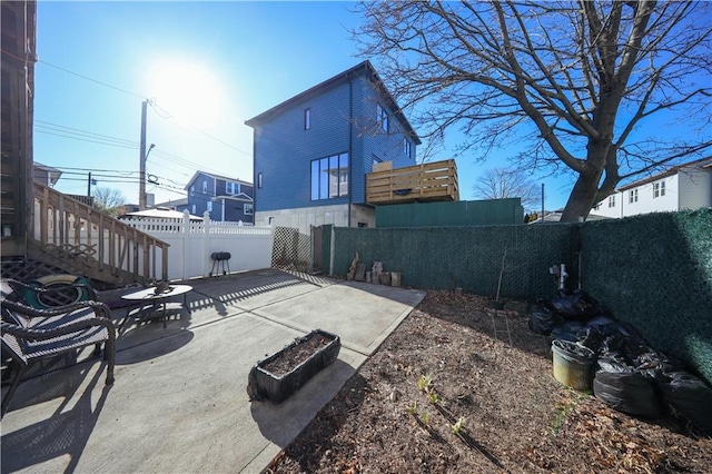 back of house featuring a patio and a fenced backyard